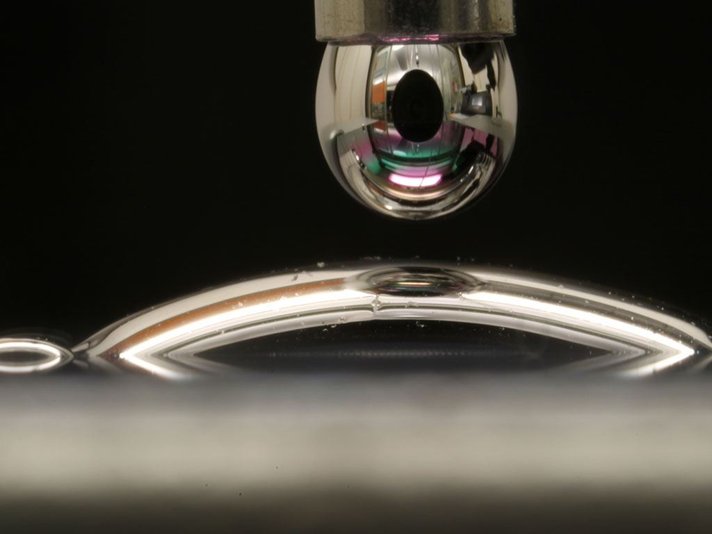 Caption:Researchers can now treat a surface so that a droplet of mercury spreads out on it, instead of beading up.