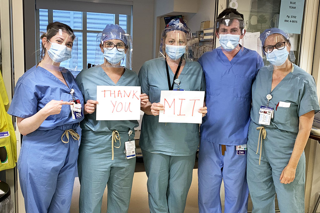 Medical worker holding an "MIT Thank You" sign