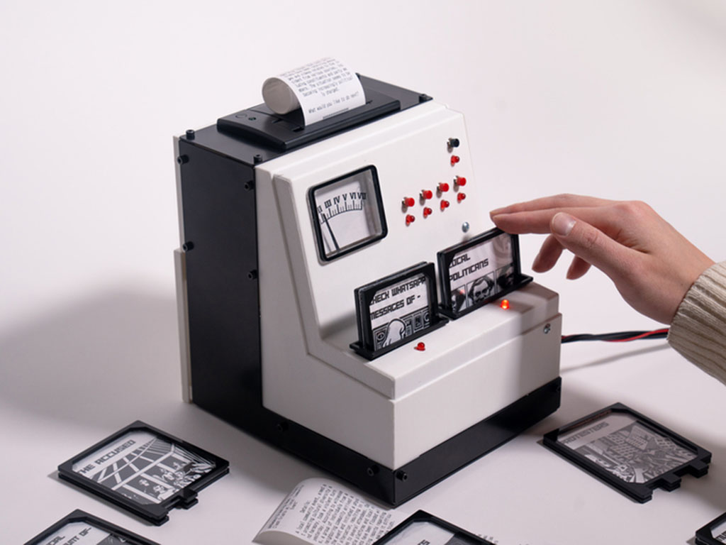 A white and black box shaped like a cash register with a hand manipulating two cards with news written on them. 