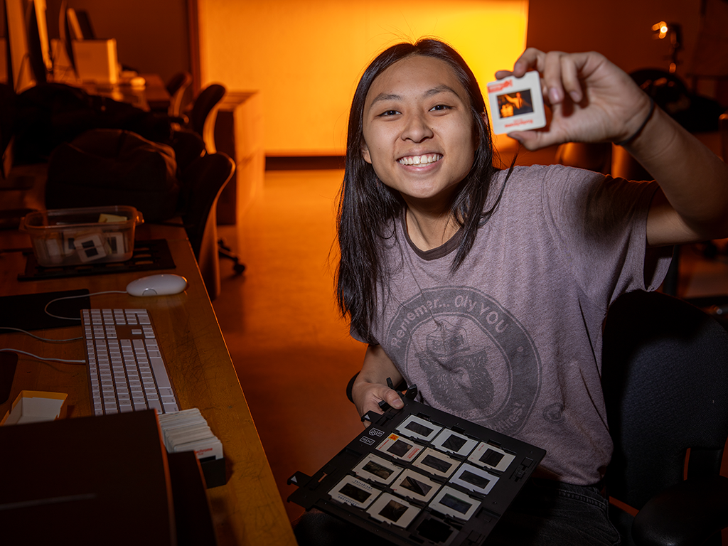 A picture of a smiling Audrey Chen holding a slide.