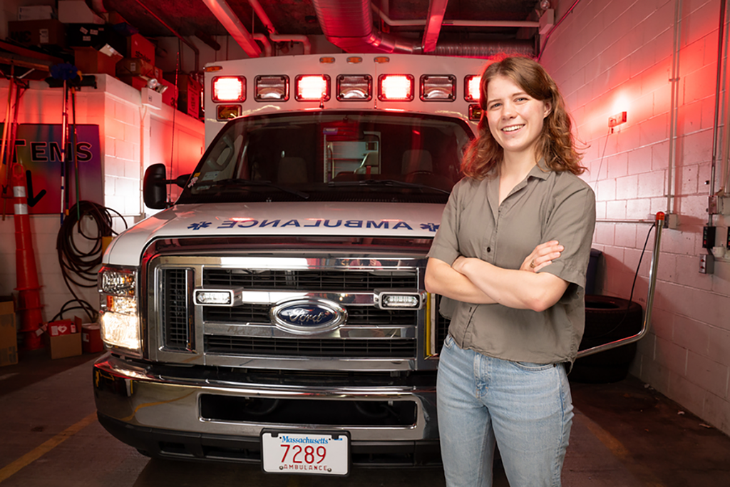 A smiling student in front of a fire truck.