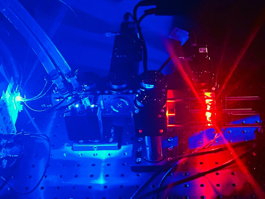 Laboratory setup with microscope and blue and red lighting