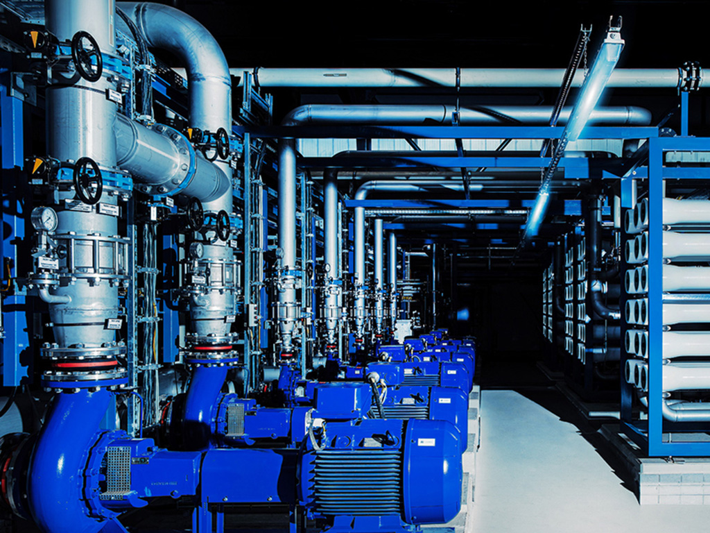 Rows of pipes and gauges inside a water treatment plant