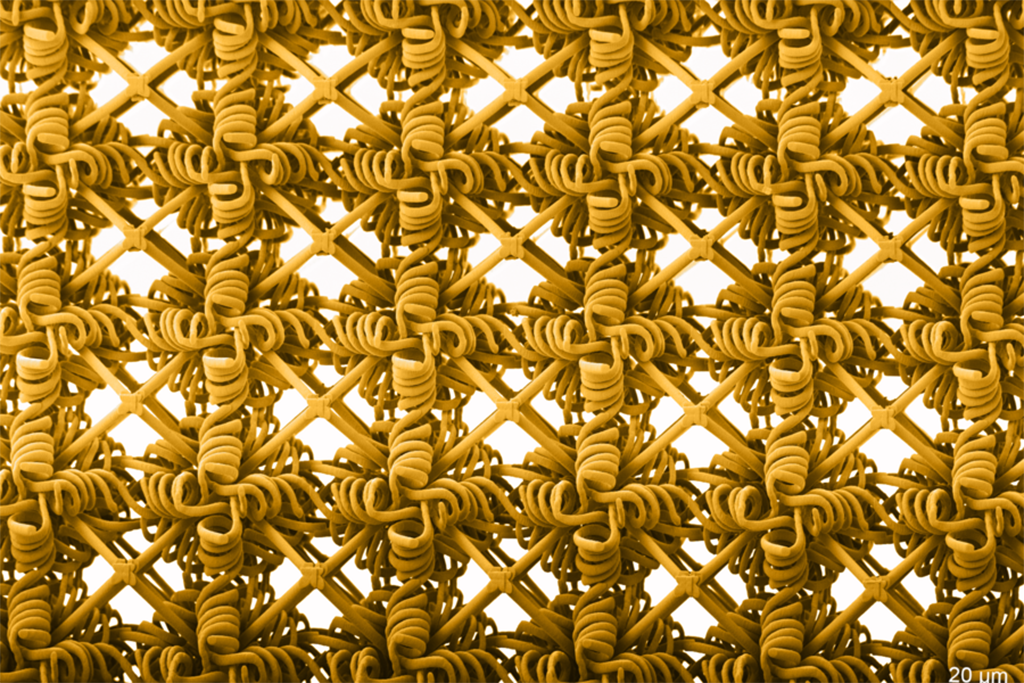 Metamaterials are synthetic materials with microscopic structures that give the overall material exceptional properties. An image of a golden woven design