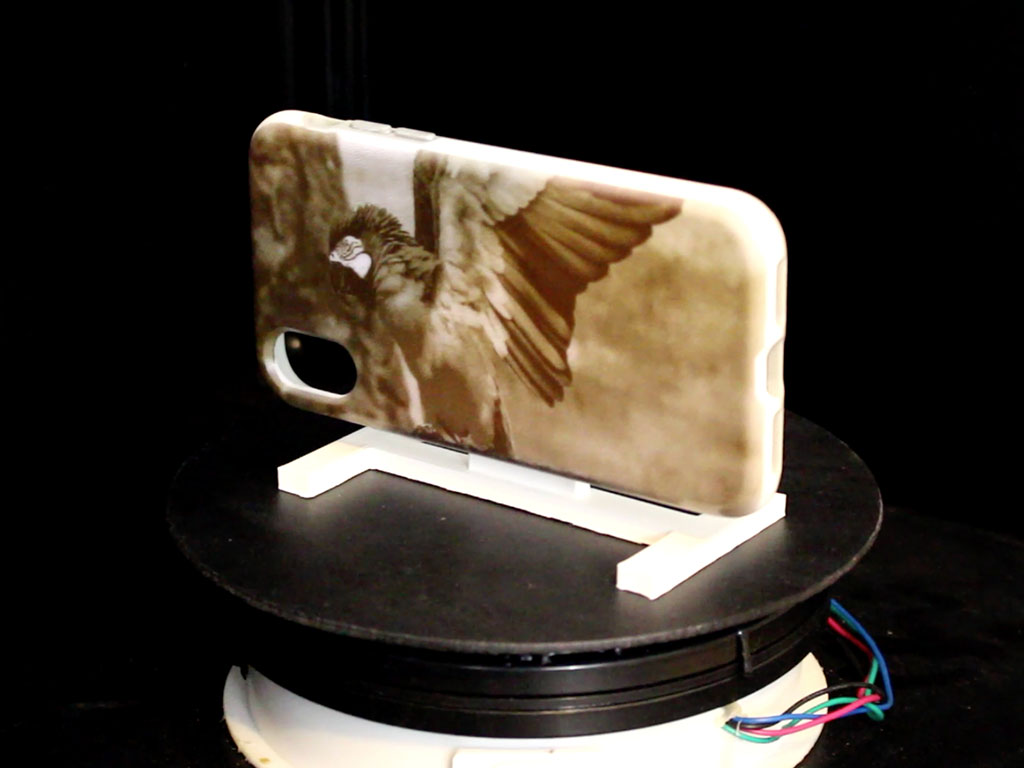 An ultraviolet (UV) light projector is used on a cell-phone case coated in light-activated dye. The projected light alters the reflective properties of the dye, creating images in just a few minutes.