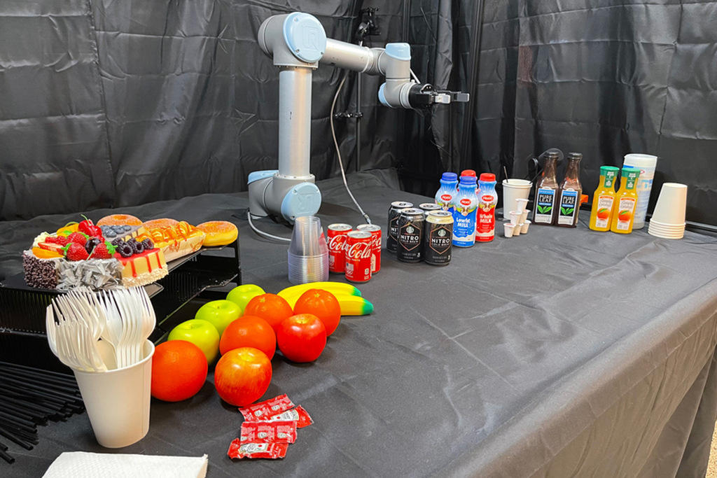 Using a novel relevance framework developed at MIT, the robot identifies and prioritizes objects in the scene to autonomously assist humans in a seamless, intelligent, and safe manner. An image of a robot surrounded by vegetables and groceries.
