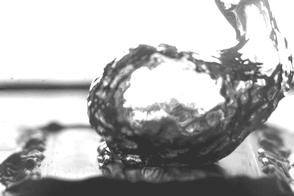 Caption:High-speed video of the researchers’ test setup shows water boiling on a specially treated surface, which causes bubbles to form at specific separate points rather than spreading out in a film across the surface, thus leading to more efficient boi