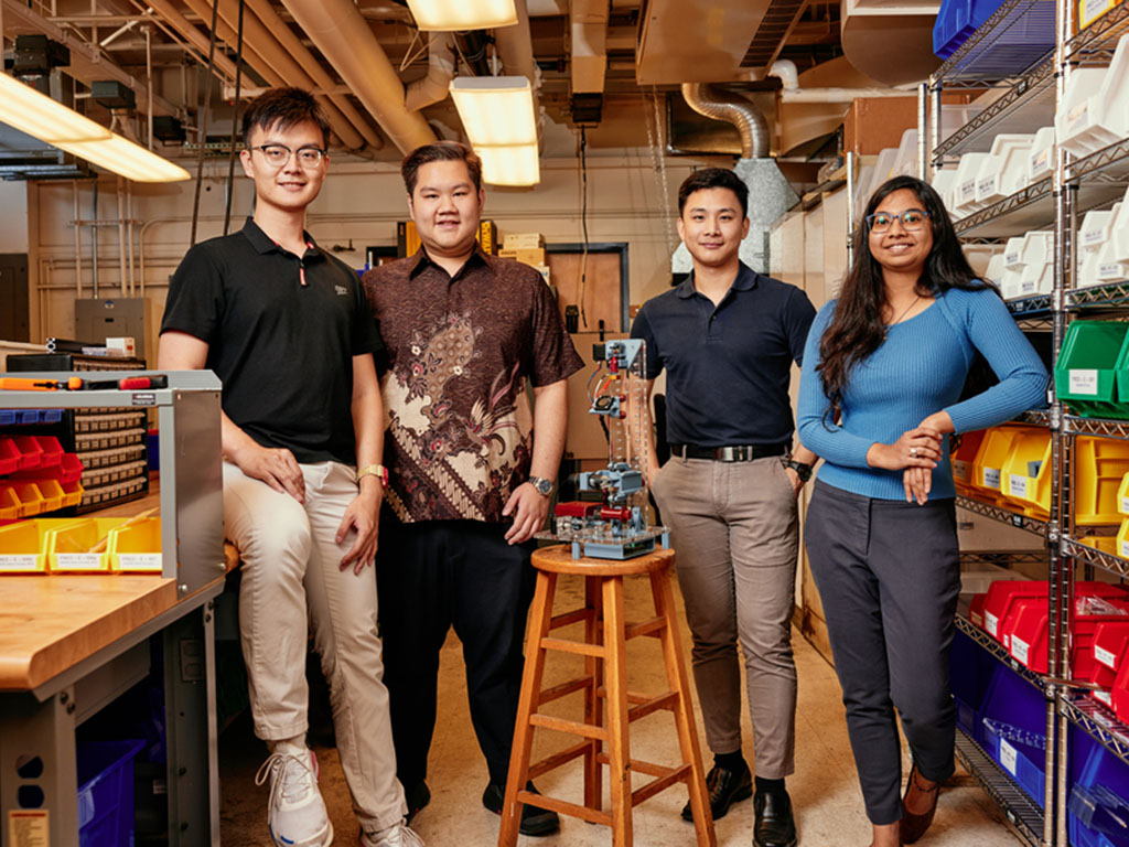 A team of MIT graduate students designed a low-cost desktop fiber extrusion device (FrED) and set up an assembly factory inside an MIT lab. Left to right: Rui Li MEng '22, Russel Bradley, Tanach Rojrungsasithorn MEng '22, and Aviva Jesse Levi MEng '22, po