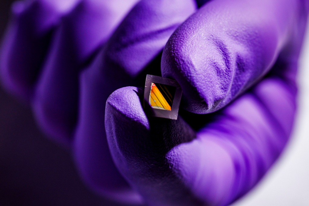 The newly developed film could enable lighter, more portable, and highly accurate far-infrared (IR) sensing devices, with potential applications for night-vision eyewear and autonomous driving in foggy conditions. A purple glove holding a small square.