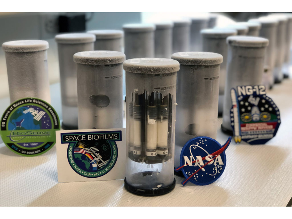 Vials with frost on the outside, and sticker logos of NASA, Space Biofilms, and Bio-Serve rest in front of them.