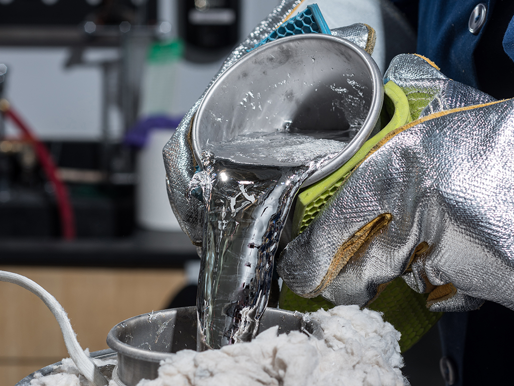 An image of a can of molten tin being poured.