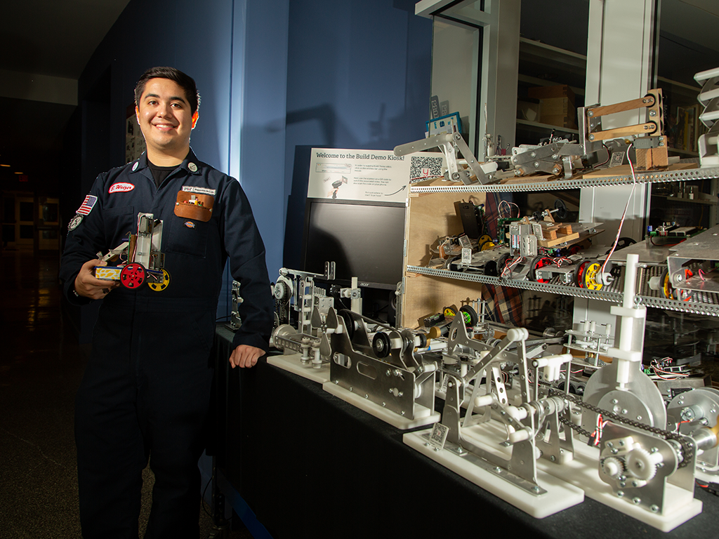 Graduate student Benjamin Weizer poses with a robot.