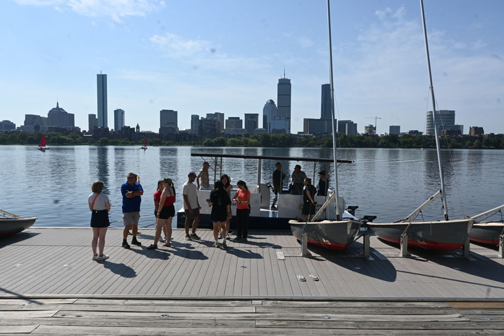 students from the Solar Electric Vehicle Team and other visitors standing on the dock