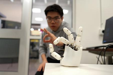 Wristband enables wearers to control a robotic hand with their own movements